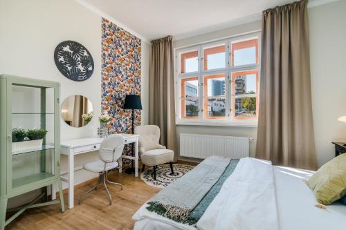 a bedroom with a bed and a desk and a window at Prague Days - Bright Apartments - Fast WiFi - Quiet Area in Prague