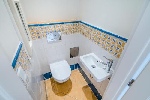 a bathroom with a toilet and a sink at Prague Days - Bright Apartments - Fast WiFi - Quiet Area in Prague