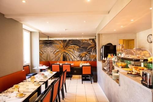 a restaurant with long tables and chairs and a counter at Best Western Alba in Nice