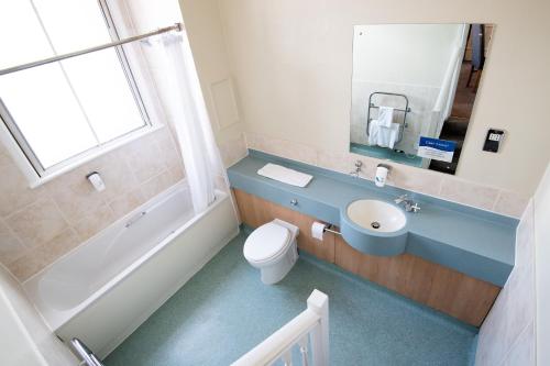 a bathroom with a sink and a toilet and a tub at Heart of England, Northampton by Marston's Inns in Daventry