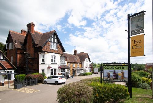 a street with houses and a sign in a town at Heart of England, Northampton by Marston's Inns in Daventry