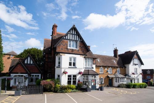 a white building with a black roof at Heart of England, Northampton by Marston's Inns in Daventry