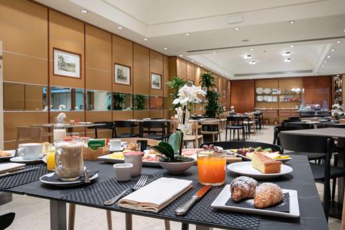 a table with food on it in a restaurant at Hotel Cappello D'Oro, BW Signature Collection in Bergamo