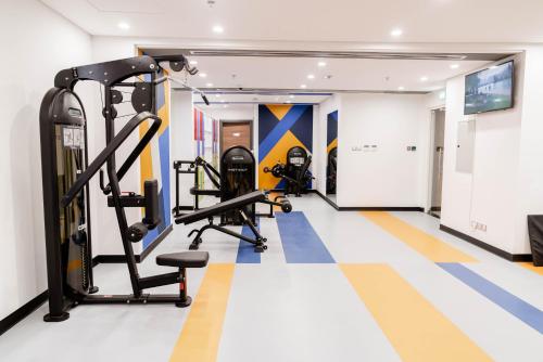 a gym with cardio equipment in a hotel room at Resivation Hotel in Dubai