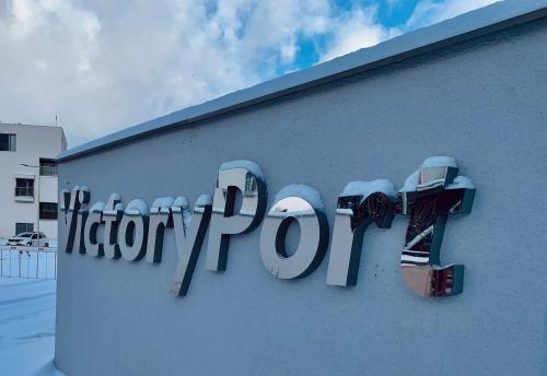 a sign on the side of a building with a camera at Apartmán Victory Port in Liptovský Mikuláš