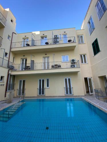 a swimming pool in front of a building at Casthotels Bristol Terme in Ischia