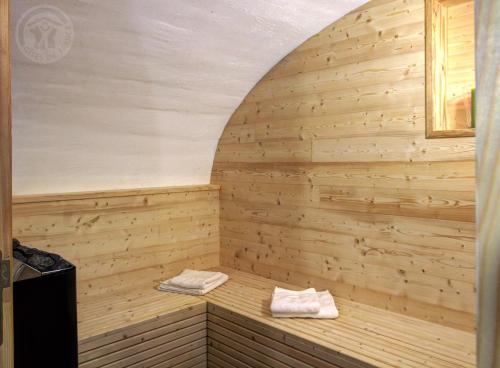 a sauna with two towels on a wooden wall at La Ferme des Galoches in Villemontais