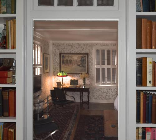 a door into a room with a desk and books at 29 India House in Nantucket