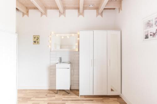 a white cabinet in a room with a white wall at Babiogórska Perełka w skandynawskim stylu z sauną i kominkiem in Jordanów