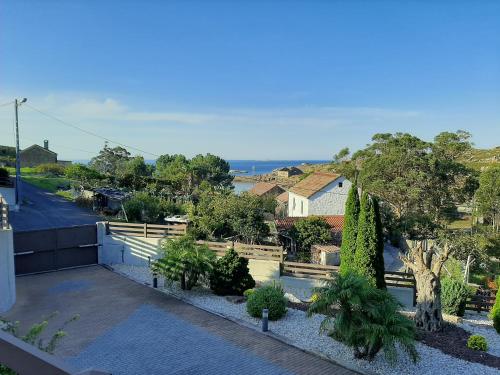 arial view of a house with trees and a street at A Ballenera de Caneliñas in Cee
