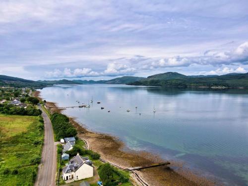 an aerial view of a lake with boats in it at Tanamuir, overlooking Loch Fyne, Strachur in Cairndow