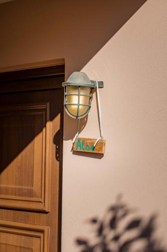 a light on a wall next to a door at Mikra Anogia Villas in Rethymno Town