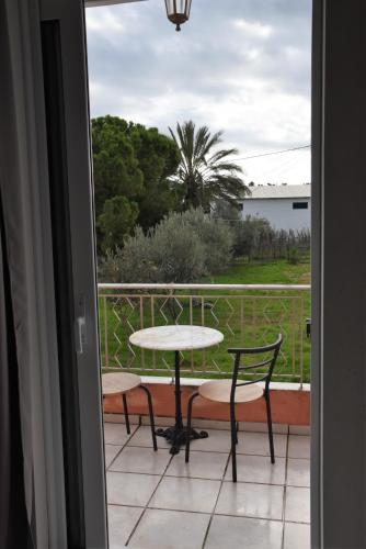 a view of a table and chairs from a door at Memory House in Megara