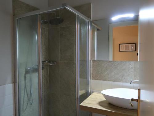 a bathroom with a glass shower and a sink at Hotel Marine in Florence