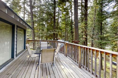 a wooden deck with a table and chairs on it at Cabin in the Pines in Joseph