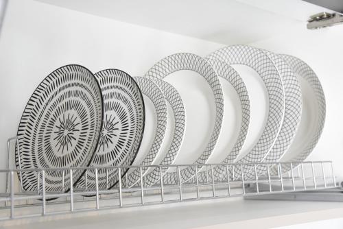 a row of plates in a dish rack at Memory House in Megara