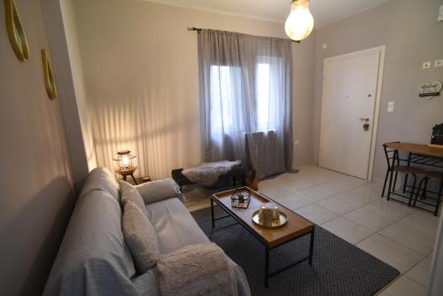 a living room with a couch and a table at Memory House in Megara