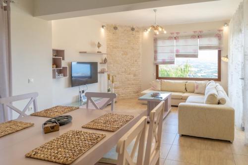 a living room with a table and a couch at Dolce Evita in Makry Gialos