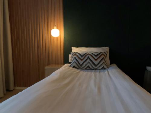 a white bed with a pillow in a room at Park Hotel Tornio in Tornio