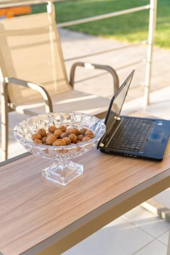 a bowl of peanuts sitting on a table next to a laptop at Asfendamos Villas in Zonianá