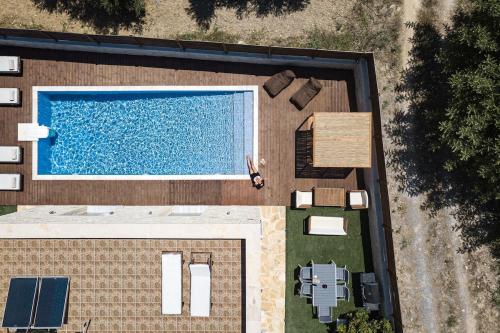 an overhead view of a house with a swimming pool at Villa Vera - With Private Pool & Jacuzzi in Pangalochori