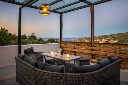 a patio with a table and chairs with a view at Villa Staras - With Private Heated Pool & Jacuzzi in Gerani