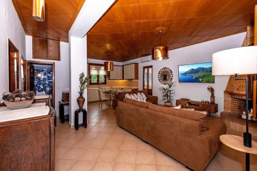 a living room with a couch and a table at Villa Avra - With Private Pool in Melidhónion