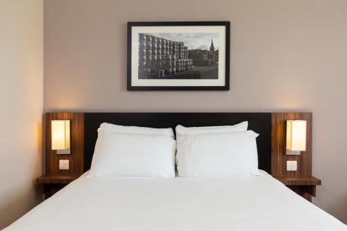 a bedroom with a bed with two white pillows at Sweet Chestnut, Dunfermline by Marston's Inns in Dunfermline