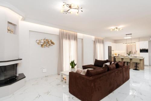 a living room with a couch and a fireplace at Villa Karouzo - With Private Pool in Agios Konstantinos