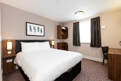 a hotel room with a large bed and a desk at Sweet Chestnut, Dunfermline by Marston's Inns in Dunfermline