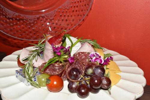 a plate of food with fruits and vegetables on it at Mosswood Bed & Breakfast in Graskop