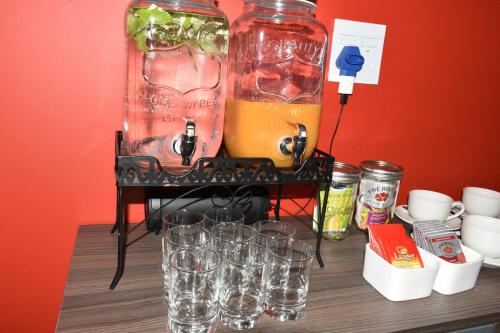 a drink machine with glasses on a table at Mosswood Bed & Breakfast in Graskop