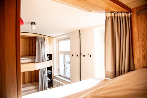 a bedroom with a bed and a window at St Josefsheim Hostel in Schruns-Tschagguns