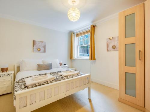 a bedroom with a bed and a window at Pass The Keys Quiet 2-Bed Apartment on the Ground Floor in Canterbury