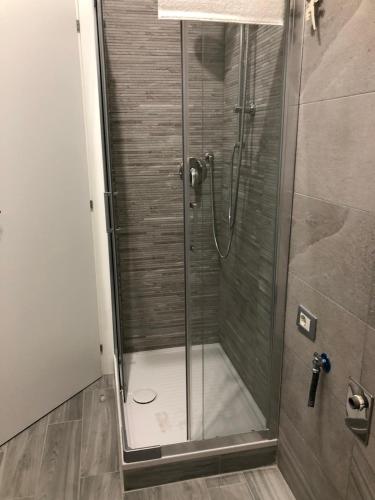 a shower with a glass door in a bathroom at LA LOGGIA in Rome