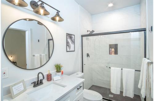 a white bathroom with a sink and a mirror at Spectacular 3 BR plus 2 and a half BA Apt Near Downtown in San Antonio