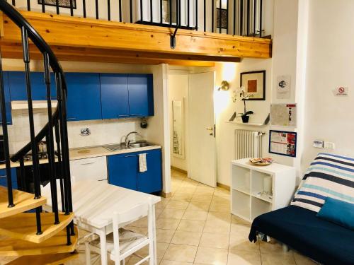uma cozinha com armários azuis e uma escada num quarto em Appartamento Galliera em Bolonha