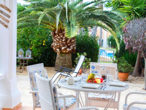 a table with a plate of fruit on a patio at Holiday Home Residencial Bel-Air by Interhome in Calpe