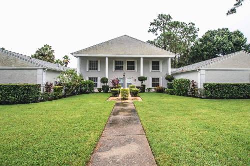 a white house with a grass yard at Golf and Tennis ~ Edgewater Escape in Wesley Chapel