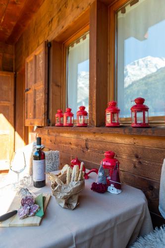 a table with red lanterns on it next to a window at Residence Monterosa in Macugnaga
