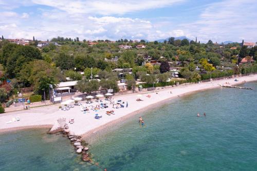 an aerial view of a beach with people in the water at Camping Porto srl in Moniga