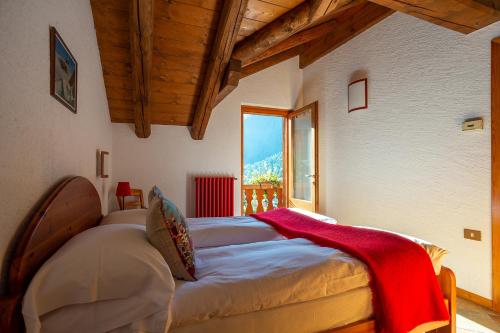 a bedroom with a bed in a room with a window at Residence Monterosa in Macugnaga