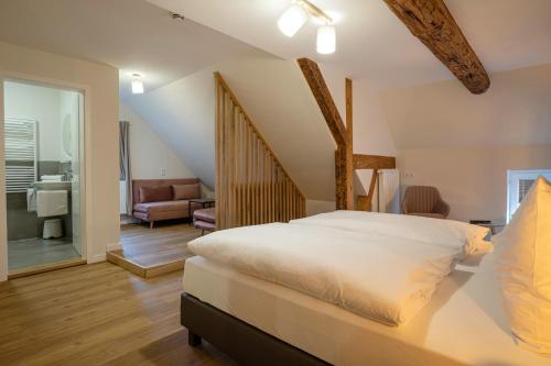 a bedroom with a bed and a living room at Altstadthotel Zur Börse in Goslar