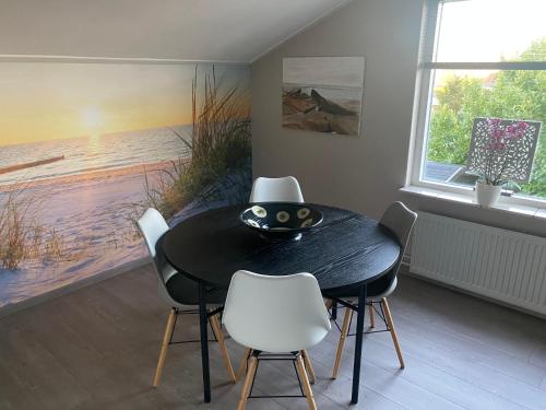 
a kitchen with a table and chairs in it at Sea la vie in Vlissingen
