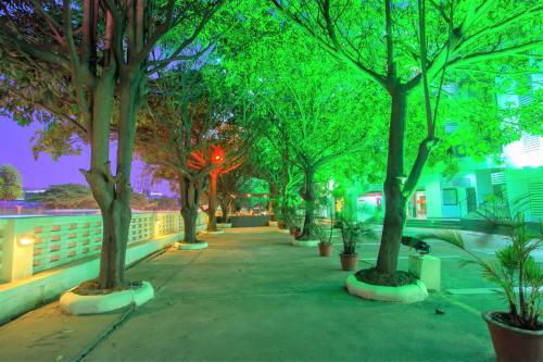 a sidewalk lined with trees at night at Ginger Bangalore- Whitefield in Bengaluru
