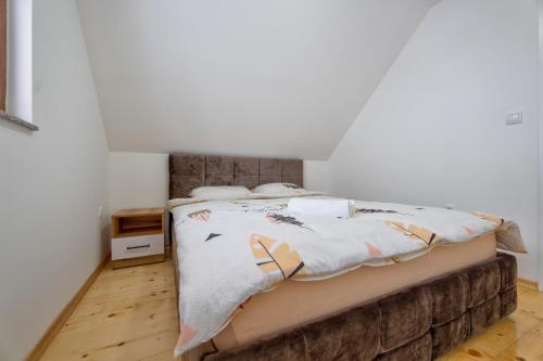a bedroom with a bed with a blanket on it at Idila Zaovinskog jezera in Zaovine