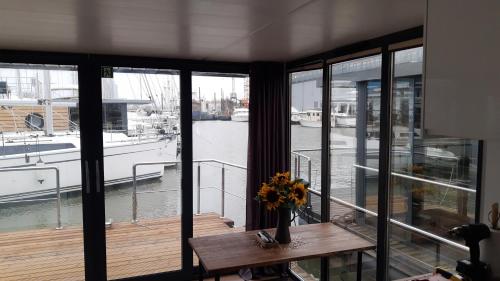 a room with a balcony with a table and a boat at La Mare Resort in Gothenburg