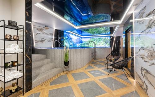 a room with stairs and a painting on the ceiling at Wrota Chałubińskiego in Zakopane