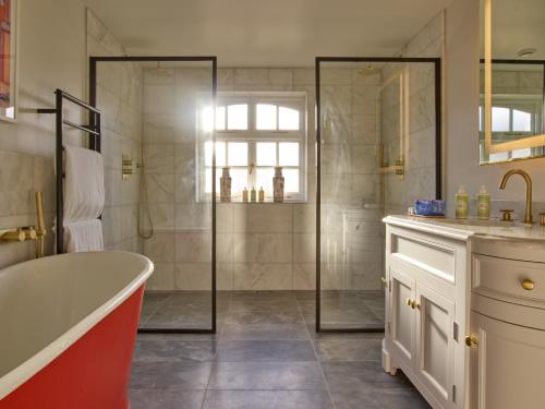 a bathroom with a tub and a shower at Bishopstrow Hotel and Spa - Small Luxury Hotels of the World in Warminster