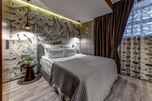 Säng eller sängar i ett rum på Бутик-отель Графтио